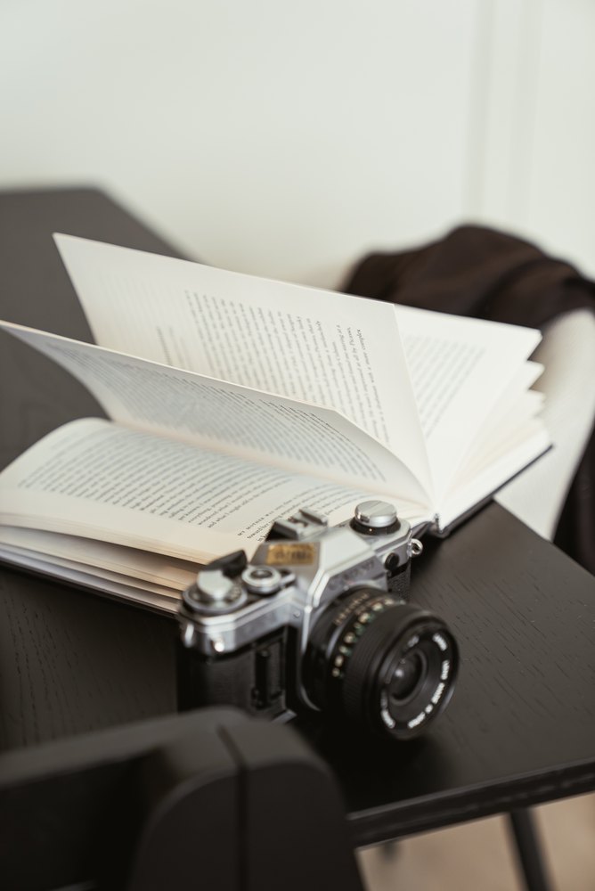 An open book and camera in a RAIBU studio