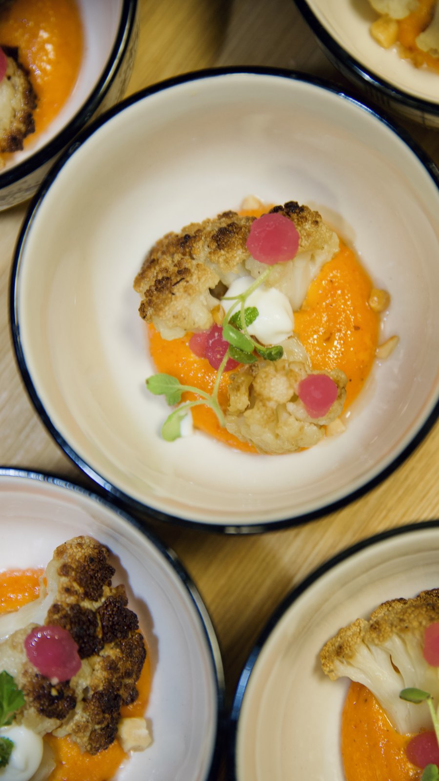 Plated dishes photographed from above at SERRA Brussels